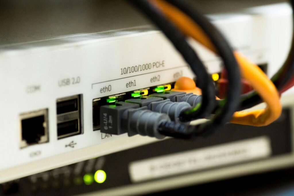 Close-up of a network switch with multiple colored wires connected to various ports.